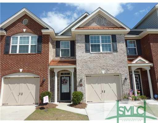 Exterior Front. Light Colored Brick Town Home