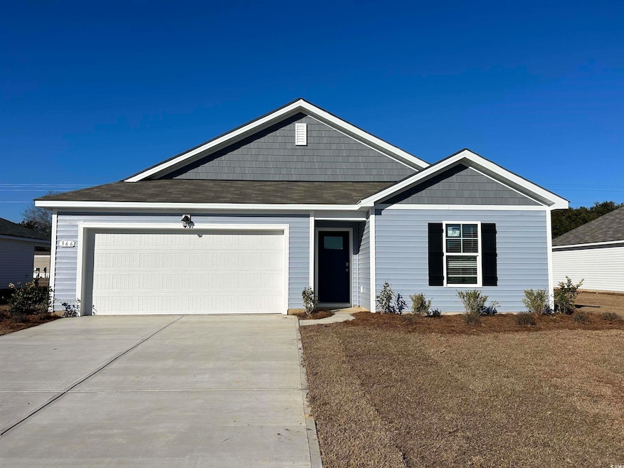 View of front of property with a garage and concrete driveway