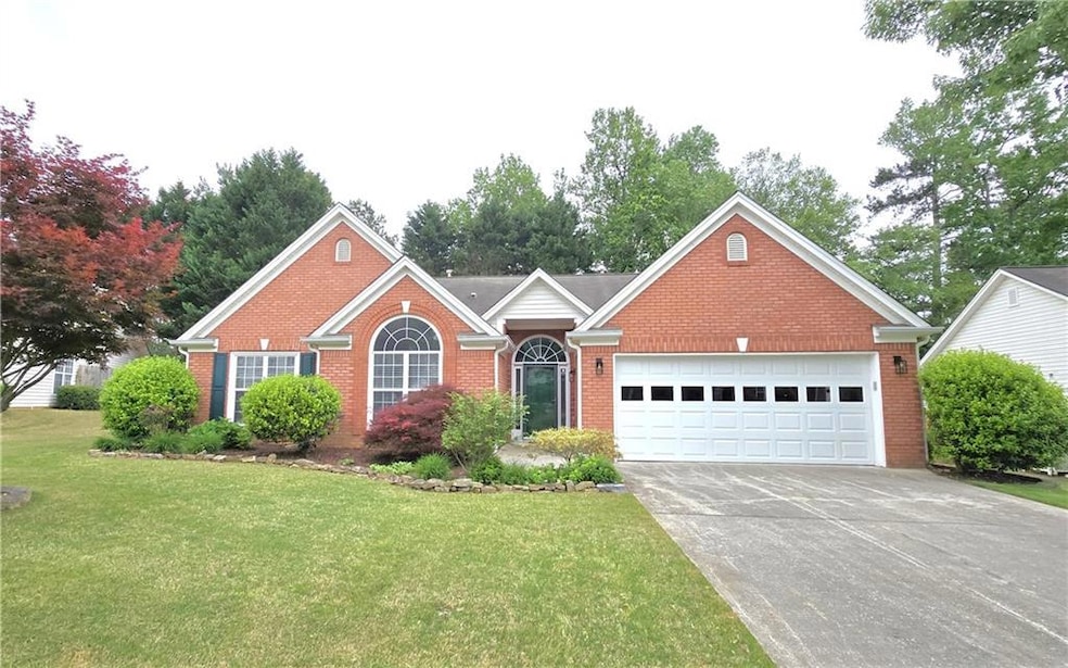 View of front facade with brick siding, a front la