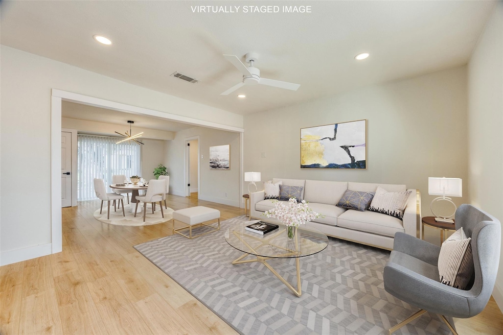 Living room featuring light hardwood / wood-style flooring and ceiling fan