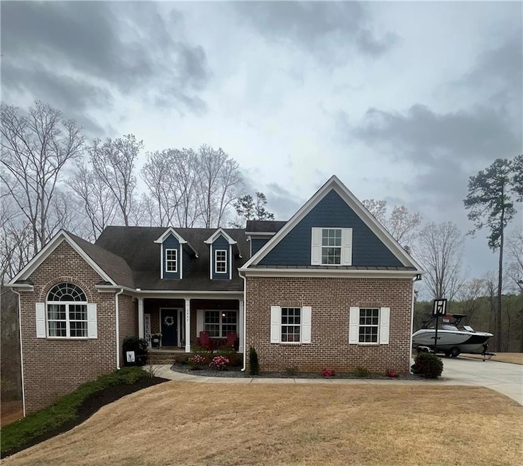 View of front of property with covered porch, bric