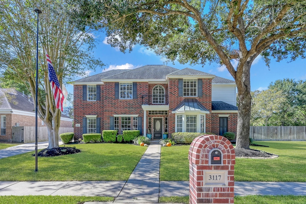This beautifull two-story brick home features classic curb appeal with timeless charm. A lush green lawn, manicured landscaping, and mature trees frame the inviting front entrance, while the elegant windows and detailed trim add to its stately presence. The home exudes warmth and sophistication, perfect for modern family living.