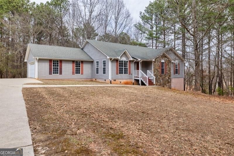 Ranch-style home featuring a garage, crawl space, 