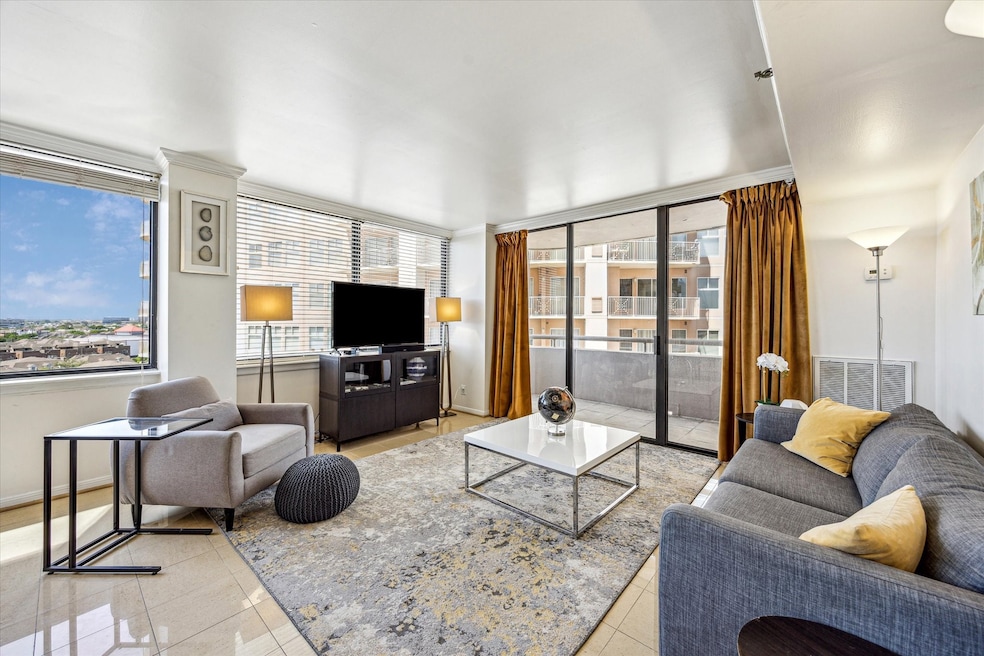 The living room features expansive windows with bl