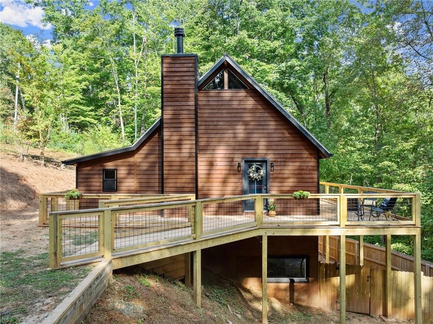 Back of house with a deck