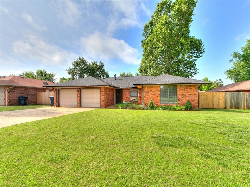 Ranch-style house with an attached garage, concrete driveway, and brick siding