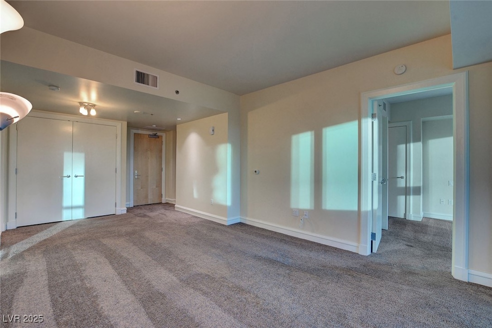 Unfurnished living room with carpet and baseboards
