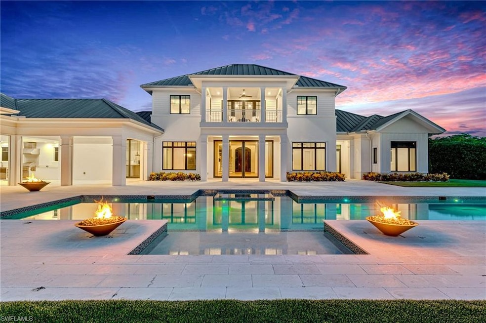 Pool at dusk featuring a patio and a fire pit