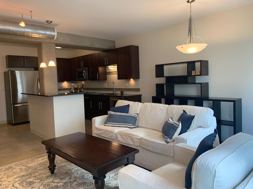 Living area with baseboards and finished concrete