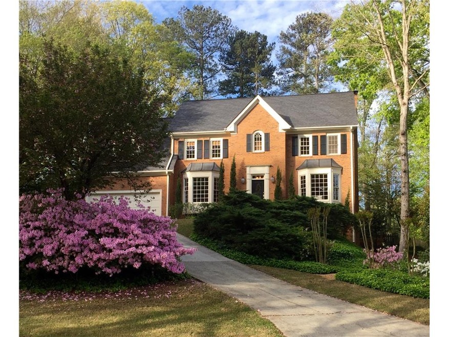 Elegant three sided brick home situated privately 