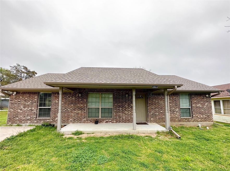 View of front of home with a front yard and a patio area