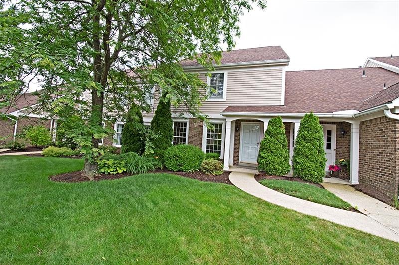 Welcoming level entry with beautifully landscaped 