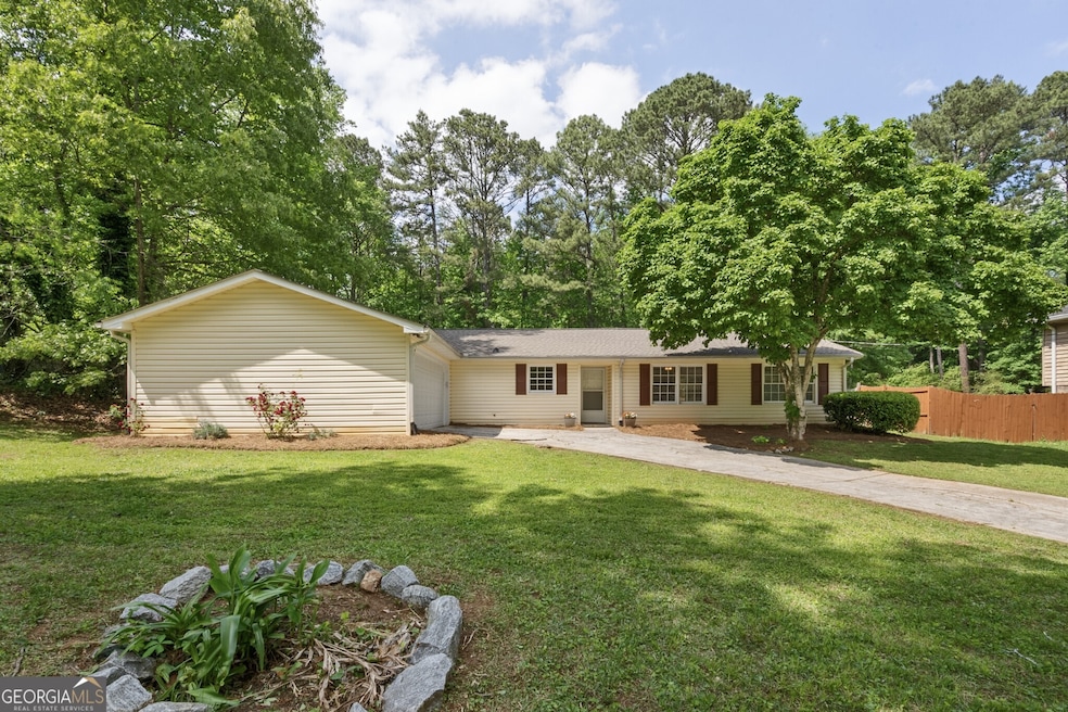 Ranch-style home with 2-car garage. Yard has matur