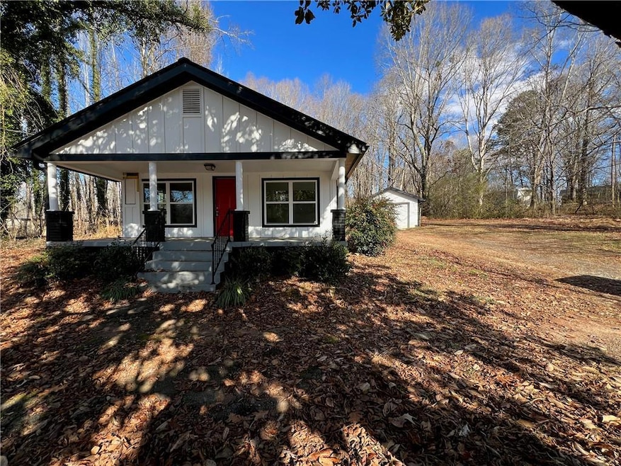 View of front facade featuring an outbuilding, a p