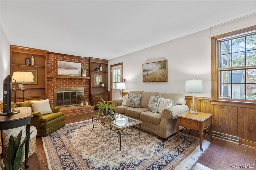 Built in cabinets flank the wood burning fireplace