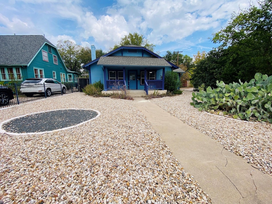 Bungalow-style home with covered porch, a shingled roof, and a chimney