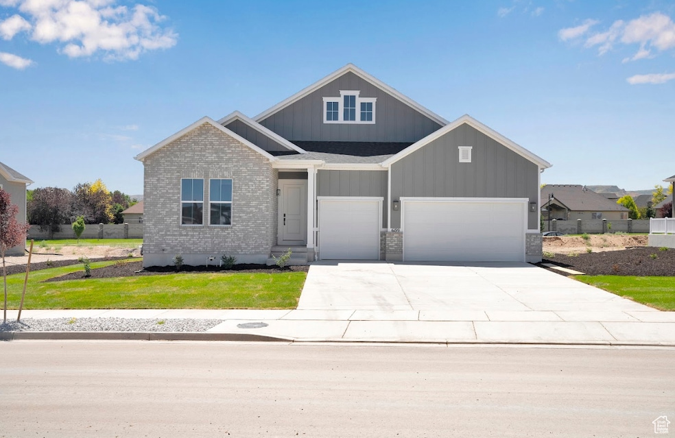 Craftsman house featuring driveway, board and batten siding, and a garage