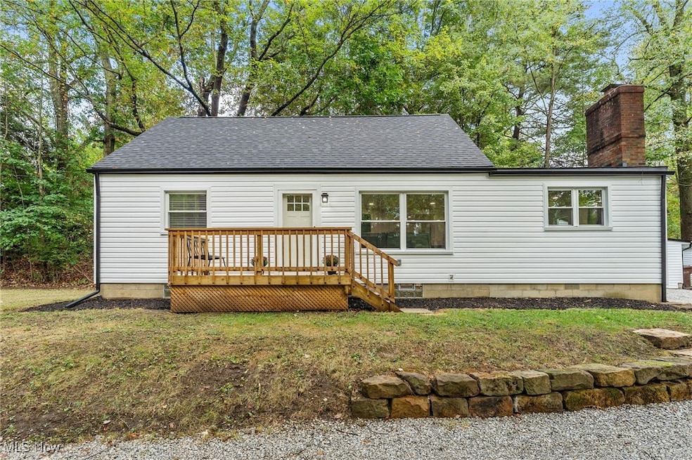 View of front of the home with white siding and front deck