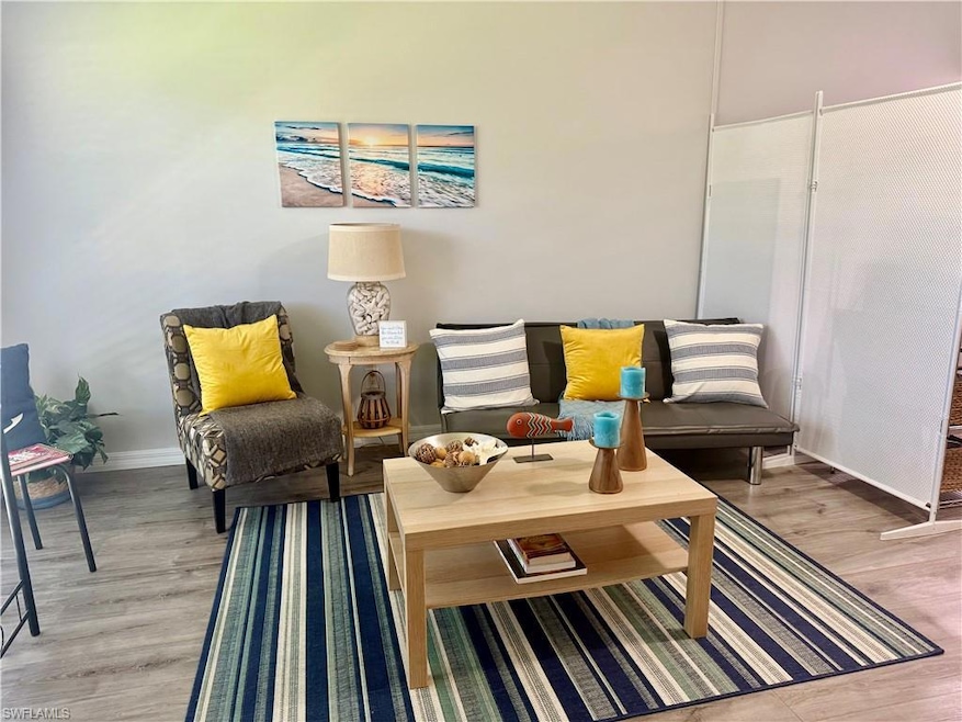 Living area with light wood-type flooring and baseboards