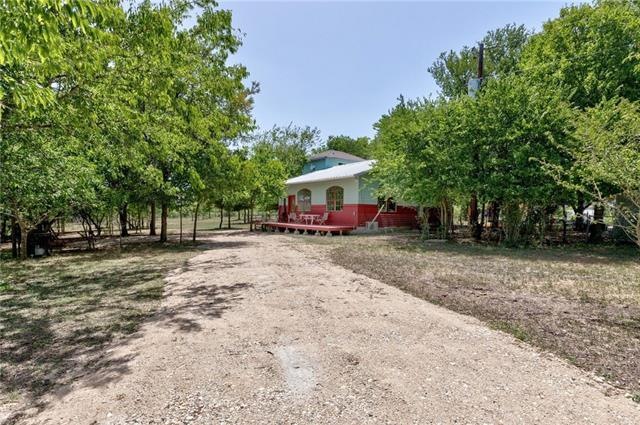 Gated entrance with drive leading to front of the 