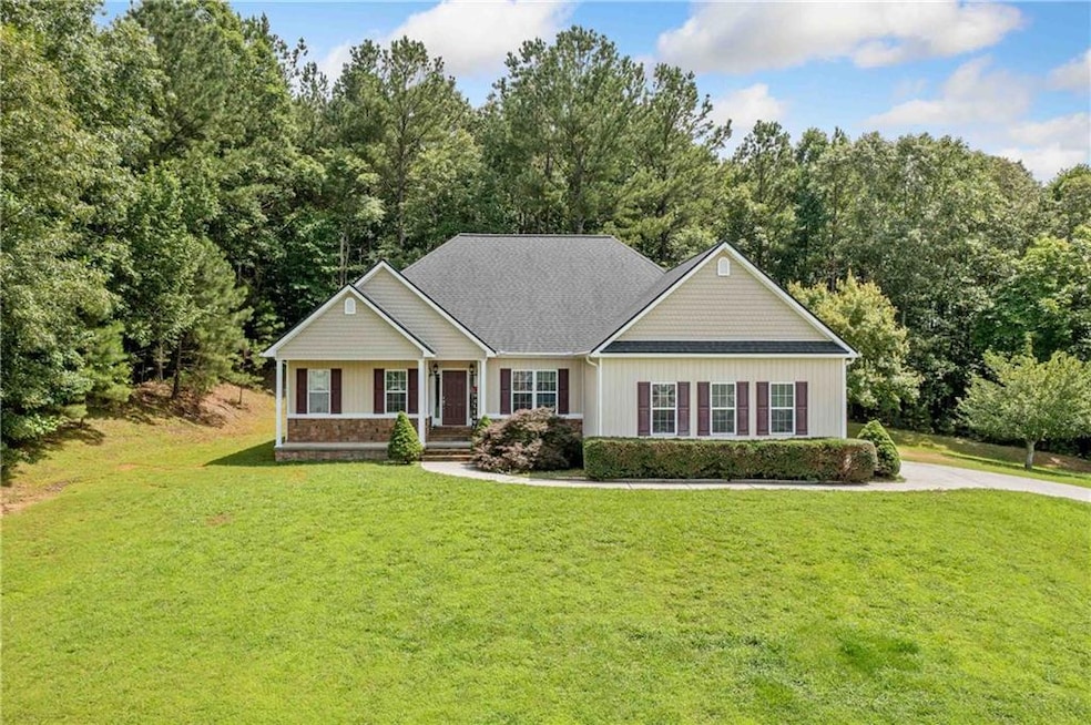 View of front of house featuring a front lawn and a porch