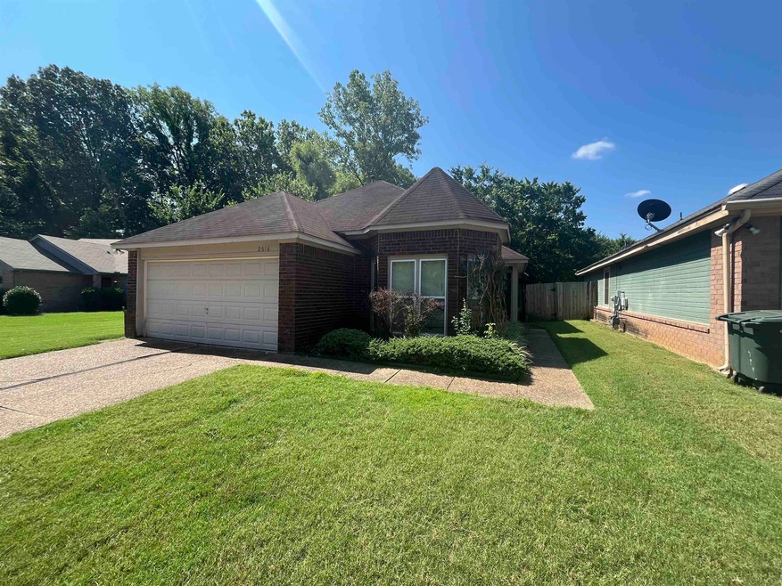 View of front of home featuring a garage and a front lawn