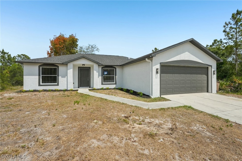 Ranch-style house featuring a garage, stucco sidin