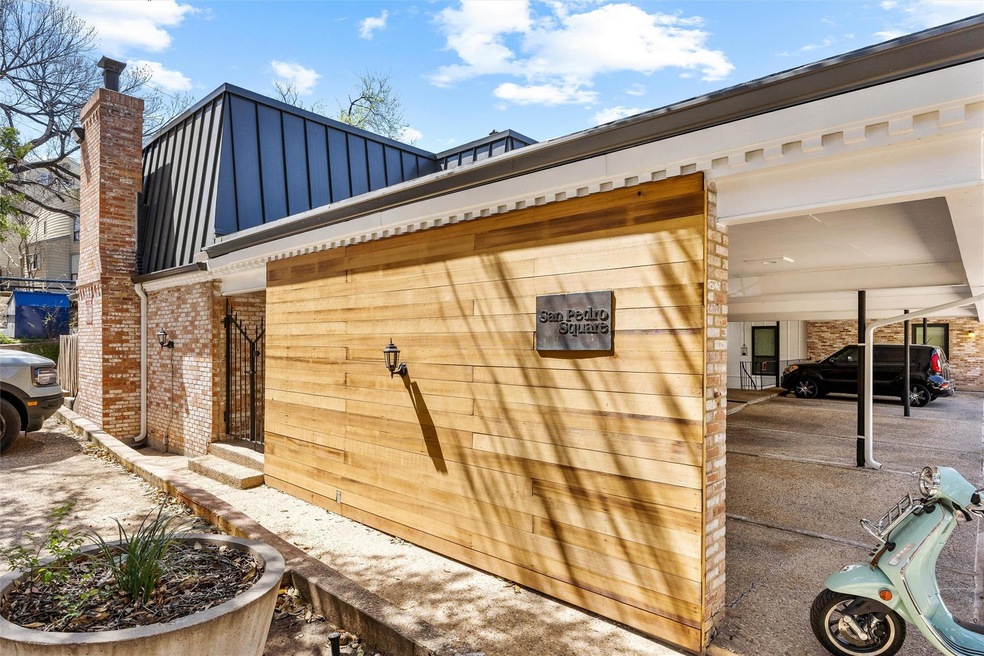 View of side of home featuring brick siding, a ch