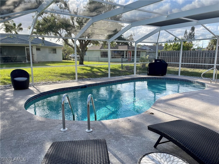 Outdoor pool with glass enclosure and a patio