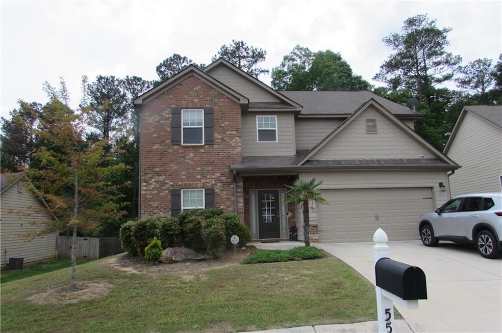 View of front facade featuring a garage and a fron