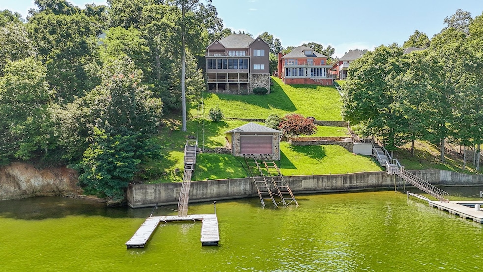 Dock area featuring a water view, a yard, and stairs