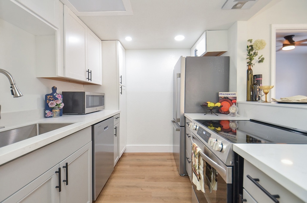 Fully renovated kitchen with stainless appliances.