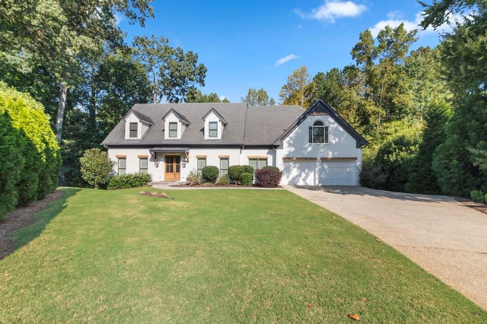 Cape cod-style house featuring driveway and a front lawn