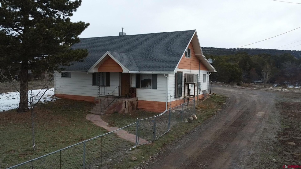Bungalow-style house with driveway, fence, and roo