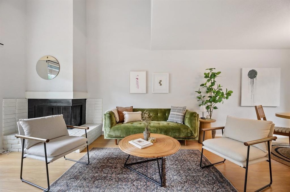 living room with soaring ceilings and fireplace