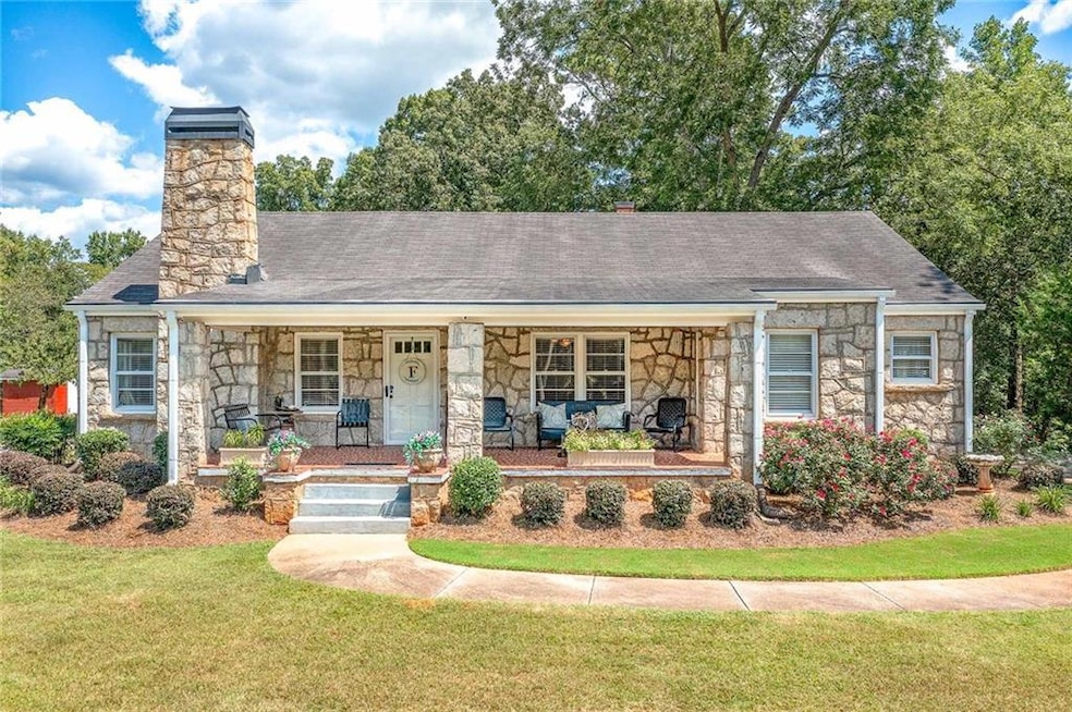 View of front of house with a front lawn and a por