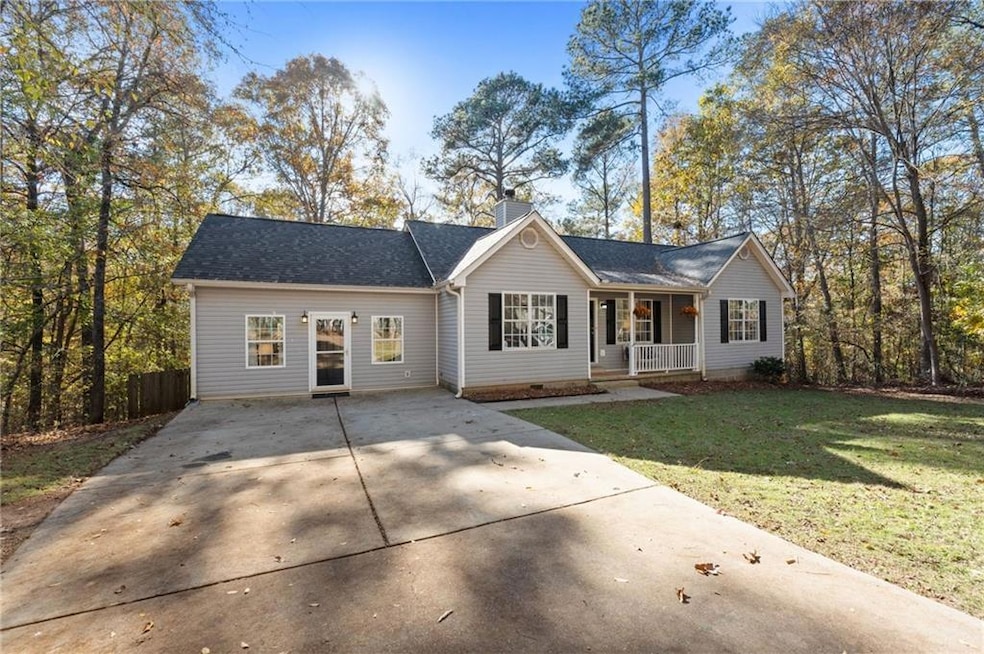 Ranch-style home featuring a porch and a front yar