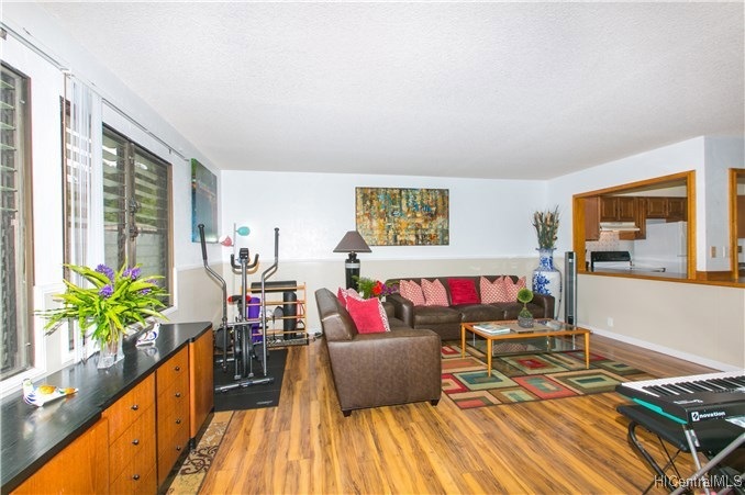 A spacious and breezy living room with large kitch