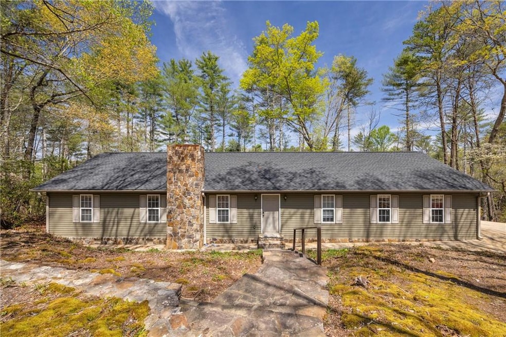 Ranch-style house featuring roof with shingles
