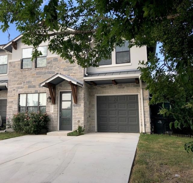 View of front of property featuring stone siding,