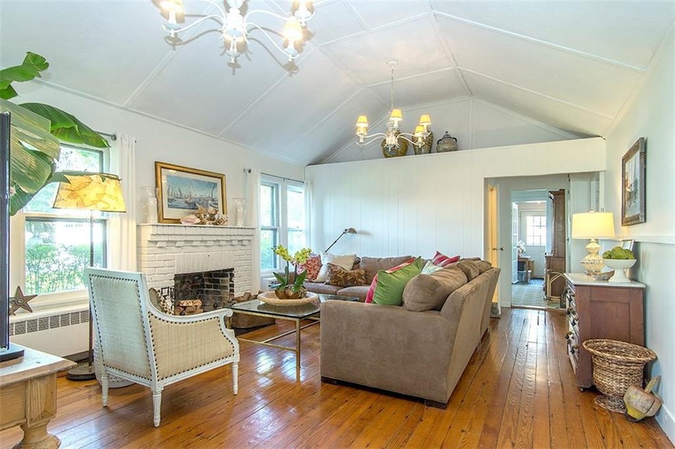 Living room with cathedral ceiling and wood burnin