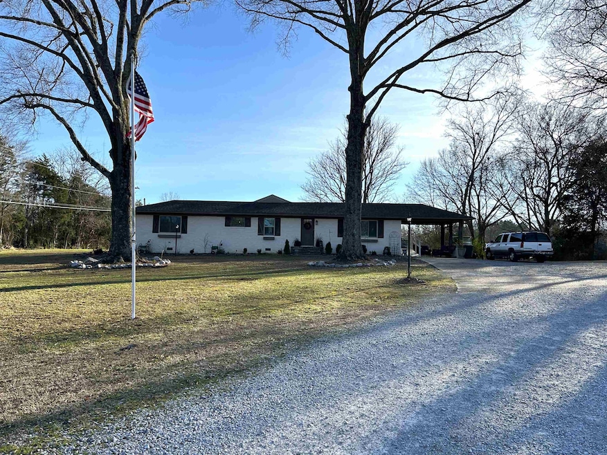 Ranch-style home with a carport and a front yard