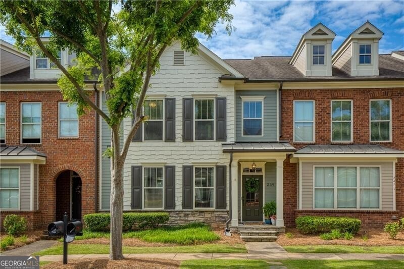 Charming Southern-style curb appeal with a freshly painted exterior (2024). Please visit www.239SouthVillageSquare.com for more information.