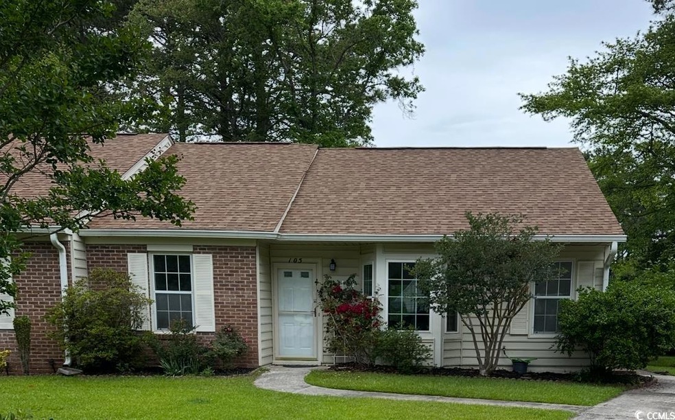 View of front facade with roof with shingles, bric
