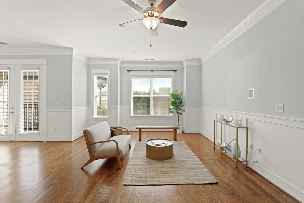 Spacious living room featuring hardwood floors, el