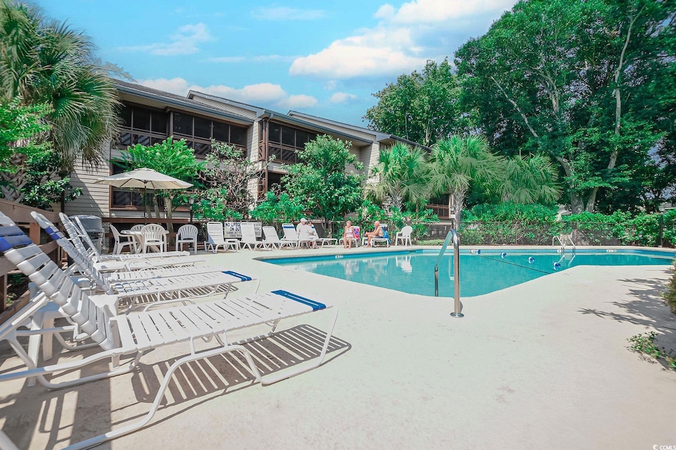 Community pool with a patio