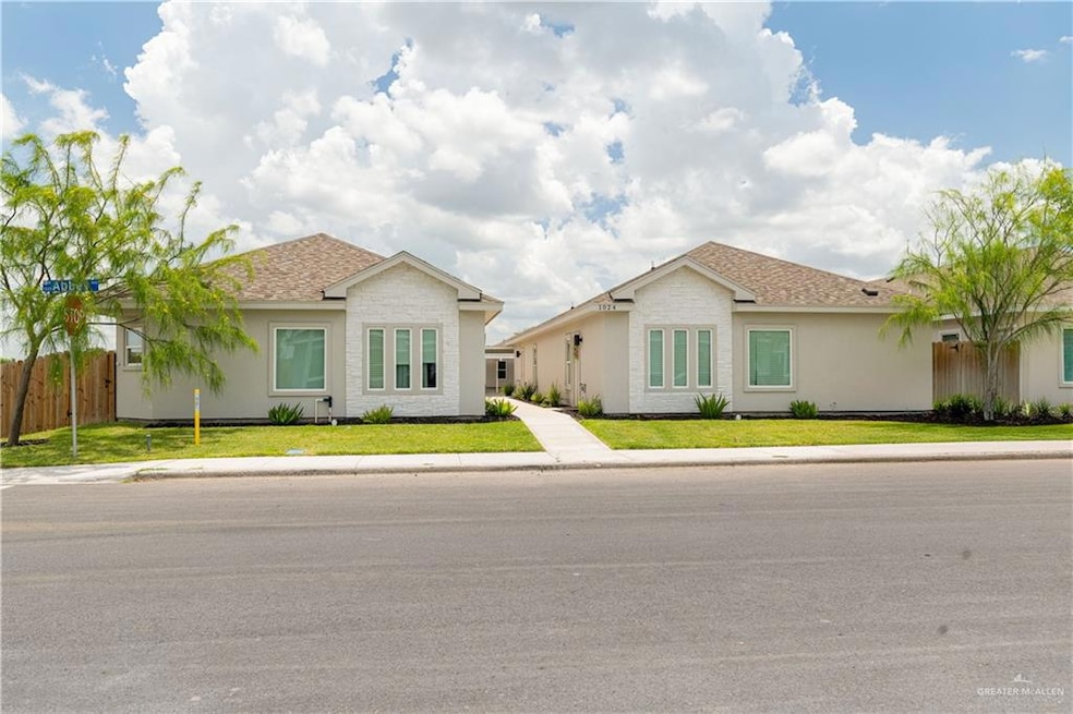 Single story home featuring a shingled roof and stucco siding