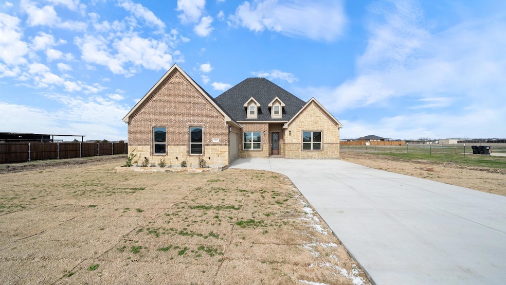 View of front of house featuring stone siding, bri
