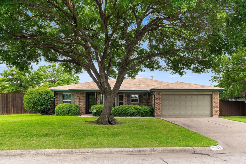 Single story home with a front yard and a garage