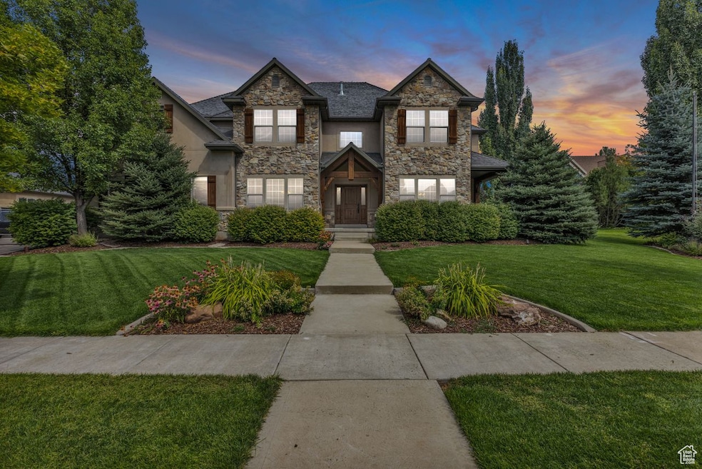 View of front of home featuring a front lawn and stone siding